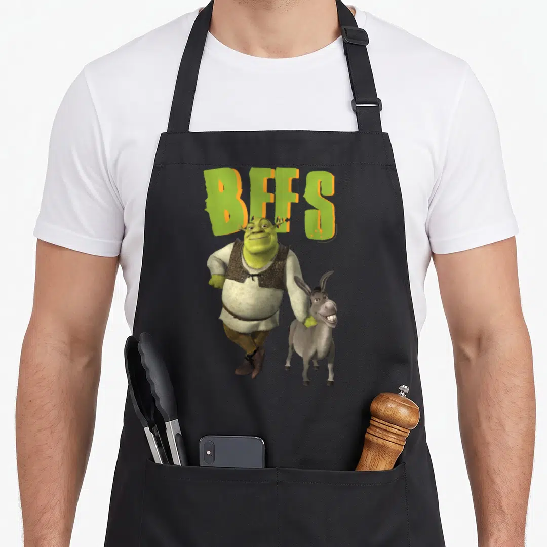 Bff donkey apron - Shrek and Donkey characters with large green BFFS text in cartoon style — shown on a black cotton canvas apron against a white background
