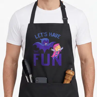 Funny starfire ravens aprons - Cartoon characters with arched text LET'S HAVE THE FUN in purple and blue — shown on a black cotton canvas apron against a white background