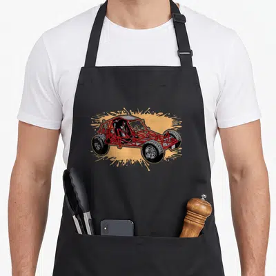 Dune road apron - Red off-road vehicle on yellow splatter background — shown on a black cotton canvas apron against a white background