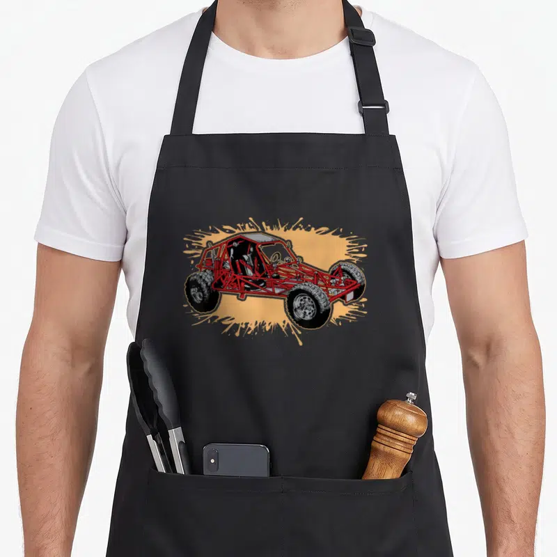 Dune road apron - Red off-road vehicle on yellow splatter background — shown on a black cotton canvas apron against a white background
