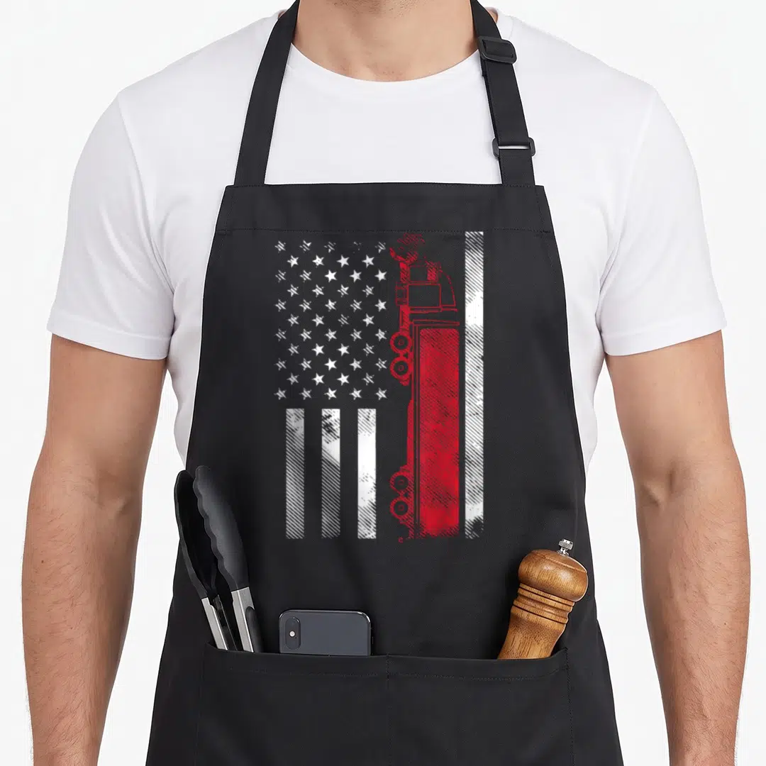 Semi american flag apron - Distressed US flag with red semi-truck silhouette replacing stripes, white stars on grey — shown on a black cotton canvas apron against a white background