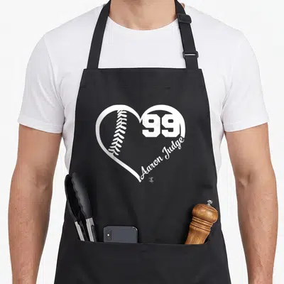Number judge apron - White heart outline with baseball, number 99, and Aaron Judge script text — shown on a black cotton canvas apron against a white background