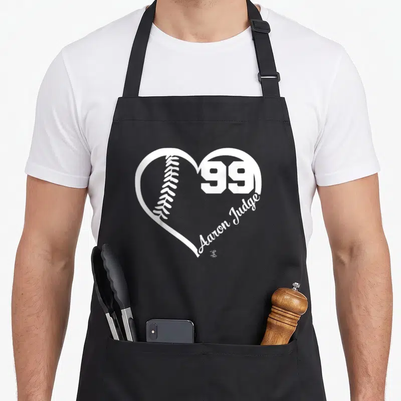 Number judge apron - White heart outline with baseball, number 99, and Aaron Judge script text — shown on a black cotton canvas apron against a white background
