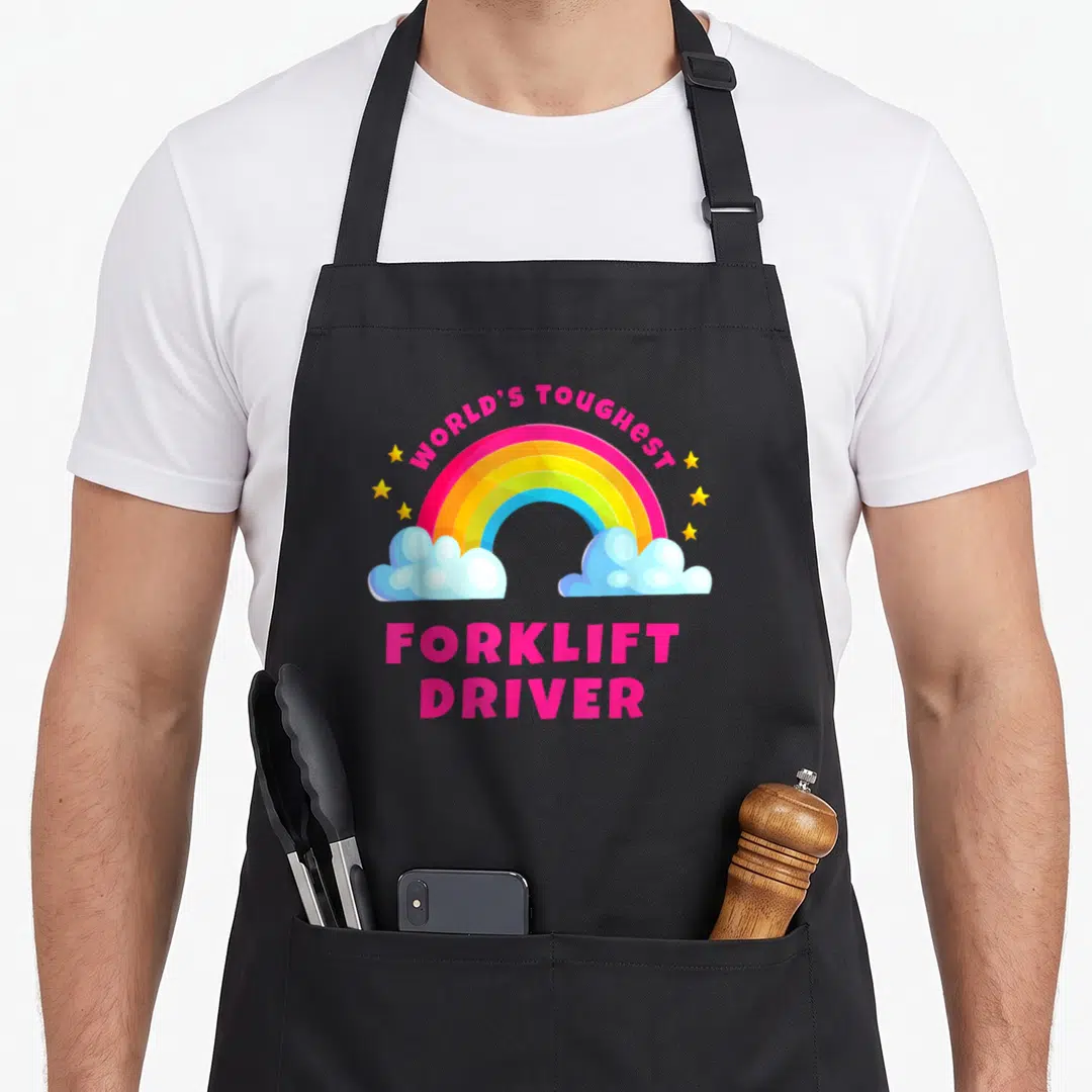 Toughest warehouse apron - Cartoon rainbow with pink text reading World's Toughest Forklift Driver between two blue — shown on a black cotton canvas apron against a white background