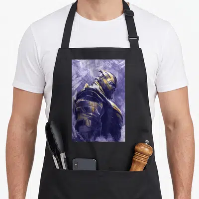 Endgame painting apron - Realistic armored figure in purple and gold with textured background — shown on a black cotton canvas apron against a white background