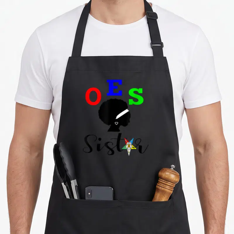 Sistar oes apron - OES letters above black woman silhouette with multicolored star and Sister text — shown on a black cotton canvas apron against a white background