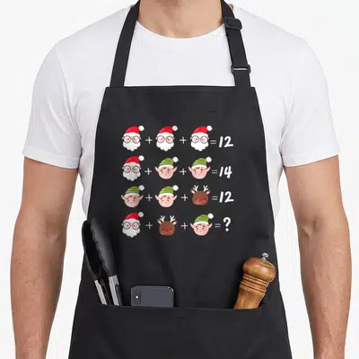 Teacher quiz christmas apron - Santa elf reindeer math equations 12 14 12 question mark cartoon heads — shown on a black cotton canvas apron against a white background