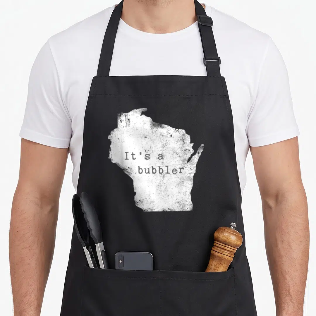 Bubbler wisconsin apron - Distressed white Wisconsin map shape with It's a bubbler text in black typewriter font — shown on a black cotton canvas apron against a white background