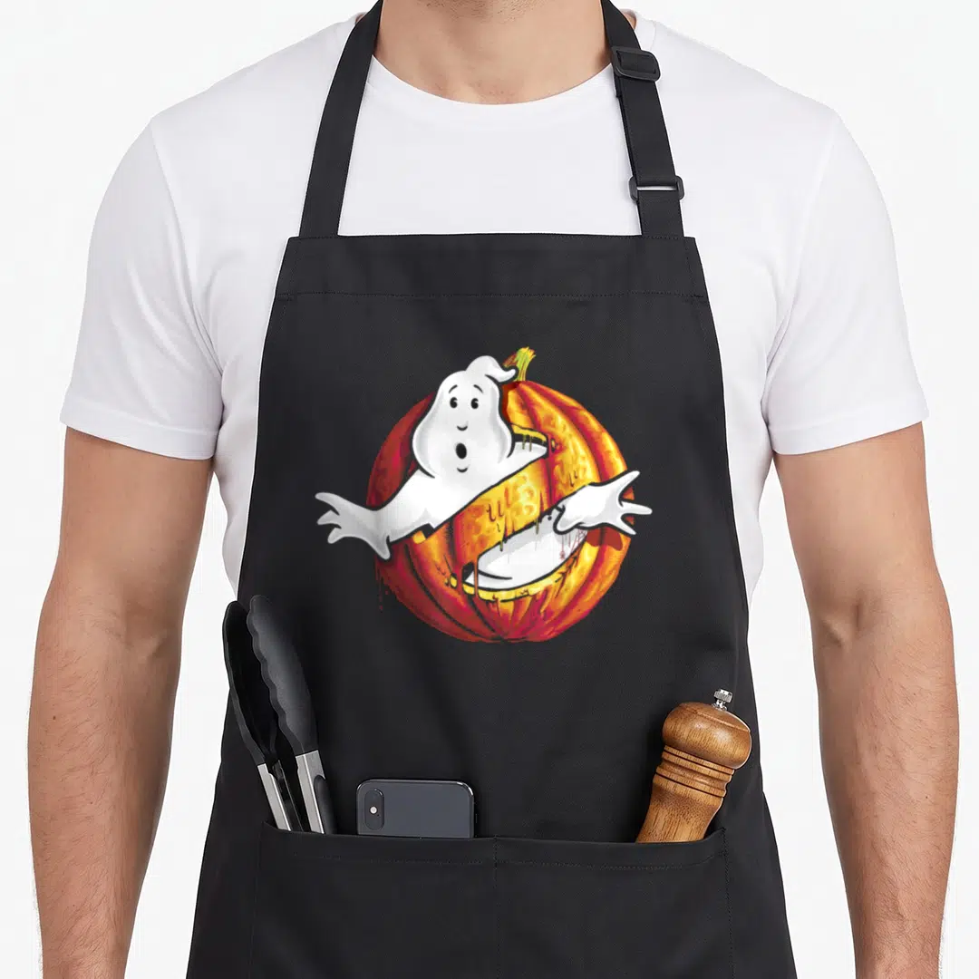 Vintage halloween pumpkin apron - White ghost hugging orange pumpkin in cartoon style with red shading — shown on a black cotton canvas apron against a white background