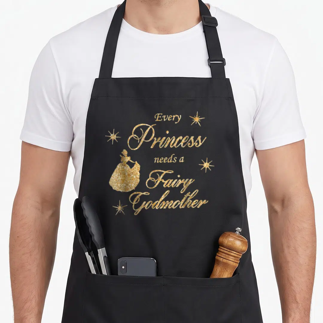 Princess fairy godmother apron - Gold glitter text Every Princess needs a Fairy Godmother with silhouette and stars — shown on a black cotton canvas apron against a white background