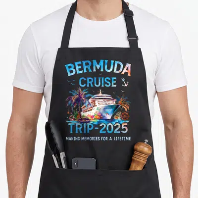 Cruise bermuda apron - Watercolor cruise ship with palm trees, anchor, lifebuoy, and 2025 trip text — shown on a black cotton canvas apron against a white background