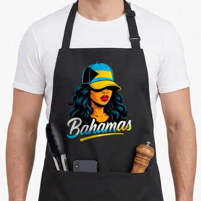 Funny bahamas bahamian apron - Cartoon woman in blue yellow and black cap with Bahamas script text — shown on a black cotton canvas apron against a white background