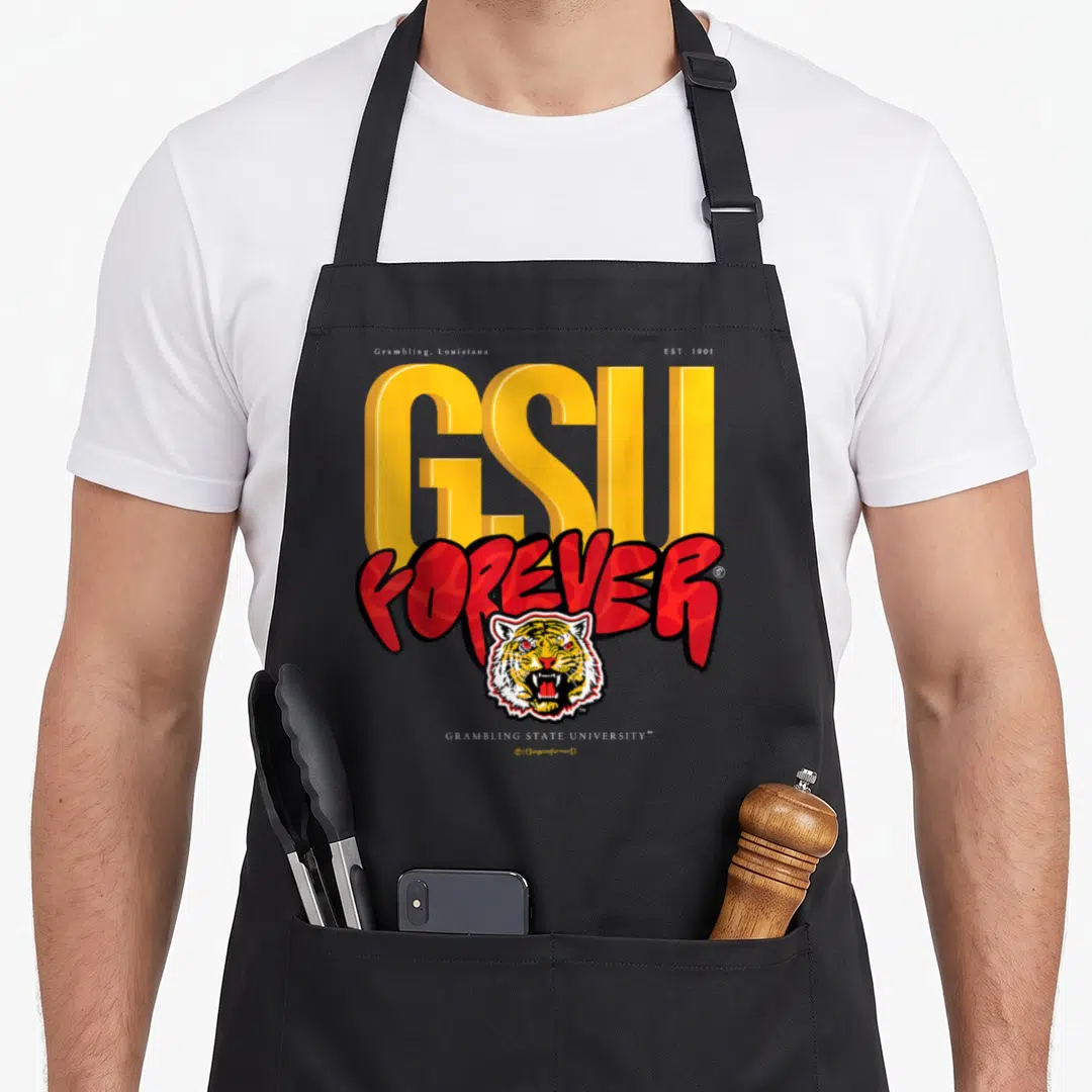 Yard essential apron - Grambling Louisiana EST 1901 GSU FOREVER tiger head typography design on black apron — shown on a black cotton canvas apron against a white background