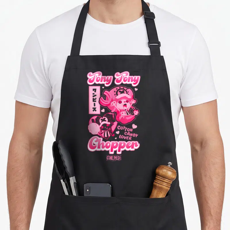 Chopper anime apron - Tony Tony Chopper holding cotton candy with Japanese text and pink hearts — shown on a black cotton canvas apron against a white background