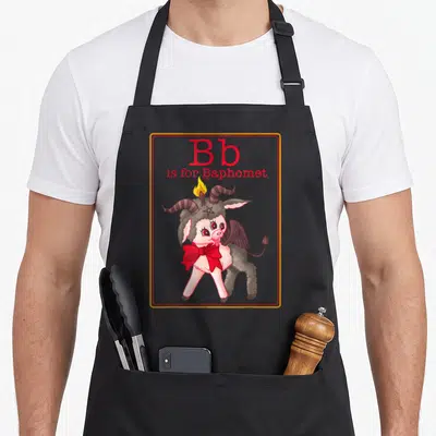 Letter game aprons - Cartoon Baphomet with red bow and Bb is for Baphomet text — shown on a black cotton canvas apron against a white background