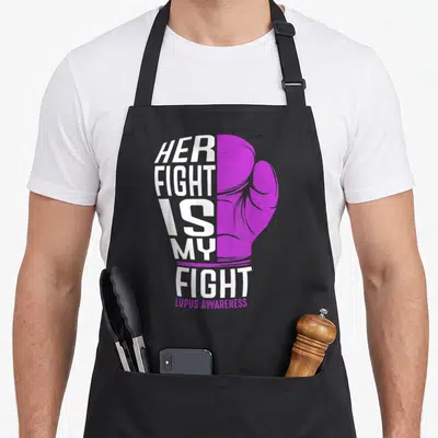 Fight lupus awareness apron - White text HER FIGHT IS MY FIGHT forming a boxing glove next to a purple glove drawing — shown on a black cotton canvas apron against a white background