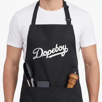 Dope urban apron - White script text reading Dopeboy with a diagonal underline stroke — shown on a black cotton canvas apron against a white background
