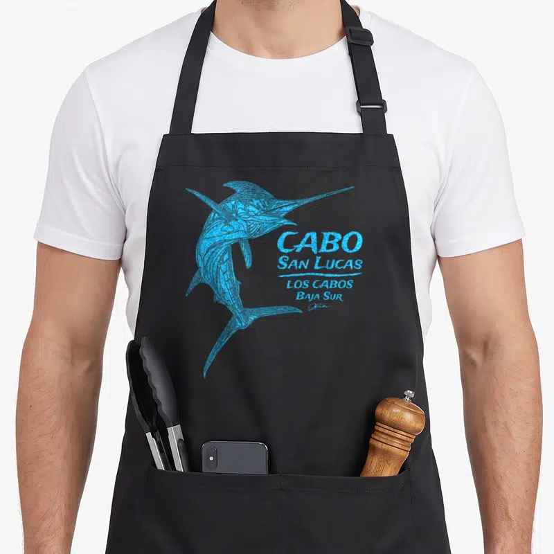 Jcomb striped apron - Blue marlin illustration next to stacked CABO SAN LUCAS LOS CABOS BAJA SUR text — shown on a black cotton canvas apron against a white background