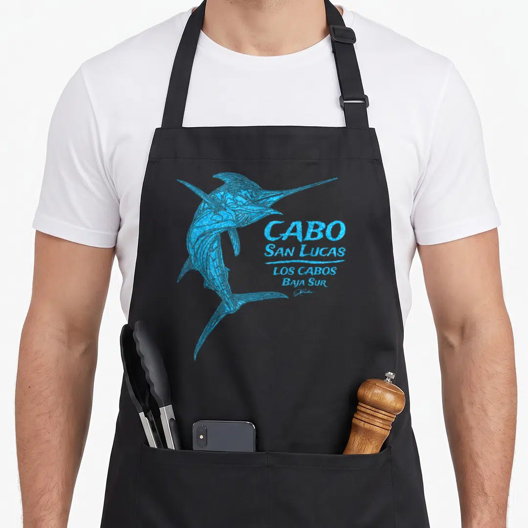 Jcomb striped apron - Blue marlin illustration next to stacked CABO SAN LUCAS LOS CABOS BAJA SUR text — shown on a black cotton canvas apron against a white background