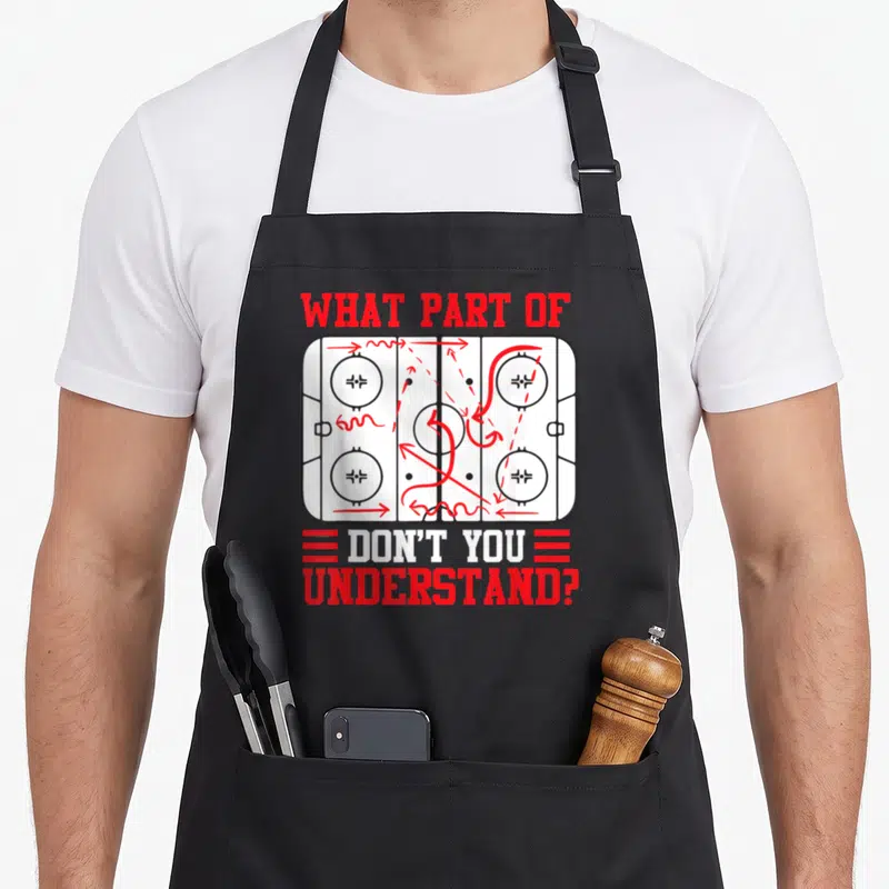 Hockey parts of an apron - Hockey rink diagram with messy red arrows and text WHAT PART OF DON'T YOU UNDERSTAND — shown on a black cotton canvas apron against a white background