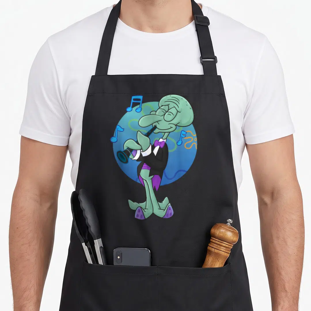 Squidward clarinet apron - Green cartoon octopus in tuxedo playing black clarinet with blue notes on blue circle — shown on a black cotton canvas apron against a white background