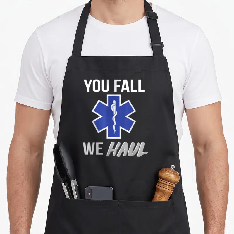 Haul fall apron - Blue Star of Life symbol between white You Fall We Haul text — shown on a black cotton canvas apron against a white background