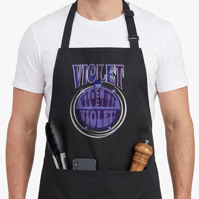 Violet factory aprons - Cartoon character inside purple sphere with VIOLET text and blue lettering — shown on a black cotton canvas apron against a white background