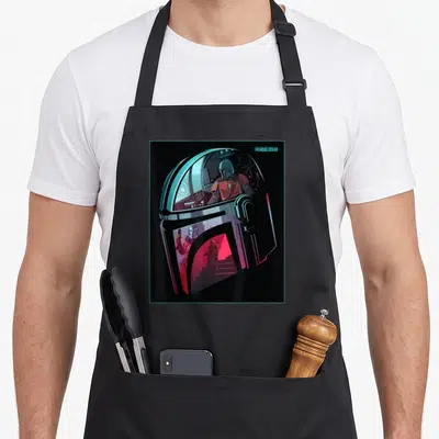 Neon star war apron - Mandalorian helmet art with internal spaceship scenes in black blue red silver — shown on a black cotton canvas apron against a white background