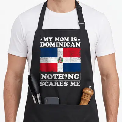 Dominica mother's day aprons - Distressed Dominican flag with white text MY MOM IS DOMINICAN NOTHING SCARES ME on black — shown on a black cotton canvas apron against a white background