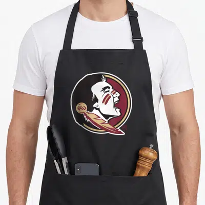 State florida apron - Cartoon profile of a man in a maroon and gold circle with a feather overlay — shown on a black cotton canvas apron against a white background