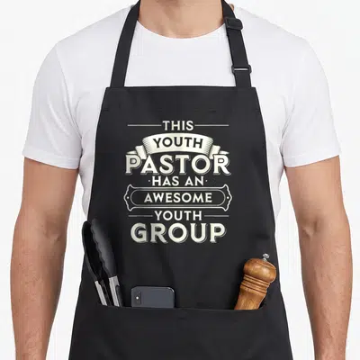 Funny pastor youth apron - White stacked text reading This Youth Pastor Has An Awesome Youth Group with ribbon — shown on a black cotton canvas apron against a white background