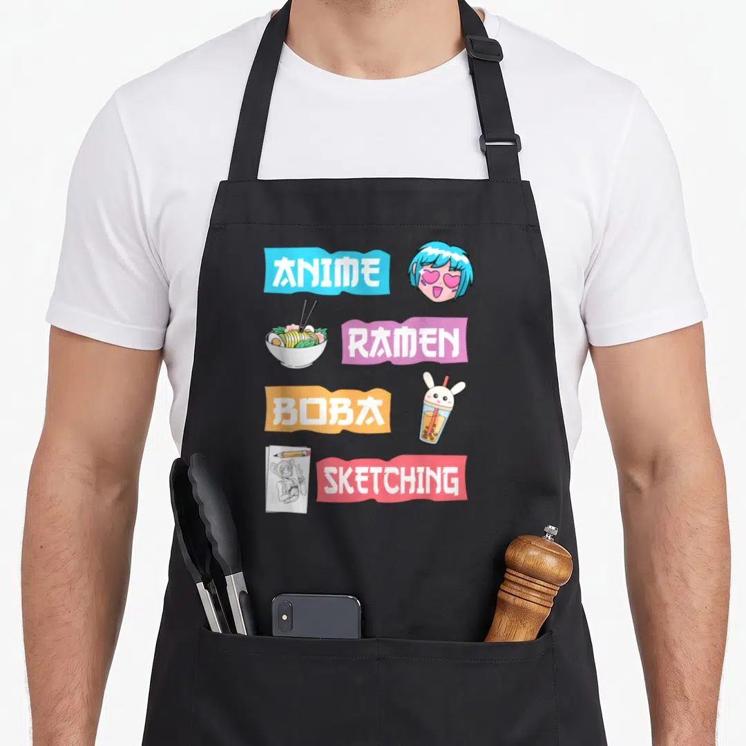 Boba anime apron - ANIME RAMEN BOBA SKETCHING banners with anime head, ramen, boba, and sketchbook illustrations — shown on a black cotton canvas apron against a white background