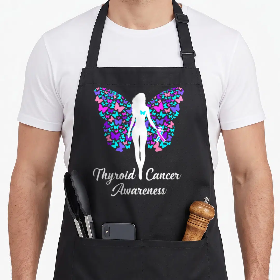 Awareness product thyroid apron - White woman silhouette with butterfly wings holding ribbon and Thyroid Cancer — shown on a black cotton canvas apron against a white background