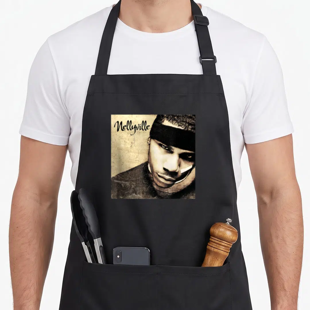 Nellyville cover apron - Man in black headband with Nellyville script text on tan background — shown on a black cotton canvas apron against a white background