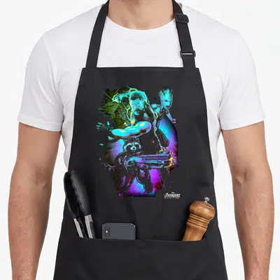 Power infinity apron - Cartoon Thor, Rocket holding weapon, and Groot in blue purple yellow and black art — shown on a black cotton canvas apron against a white background