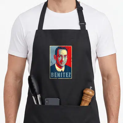 Judge gifted apron - Retro stylized portrait of Benitez in red and blue-grey block lettering — shown on a black cotton canvas apron against a white background