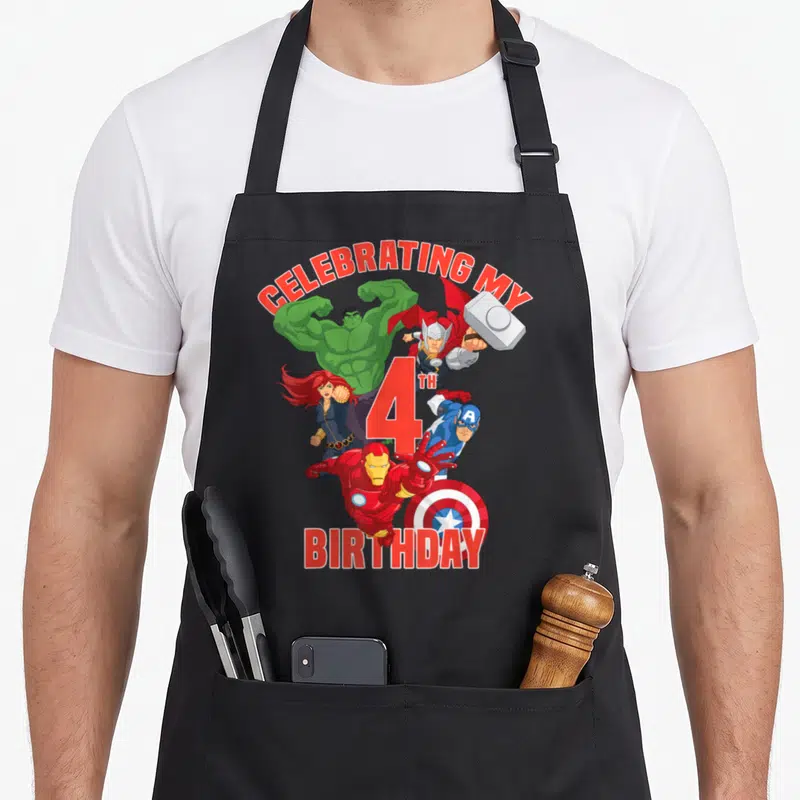Celebrating 4th birthday apron - Avengers characters surrounding a large red number four with celebratory text — shown on a black cotton canvas apron against a white background