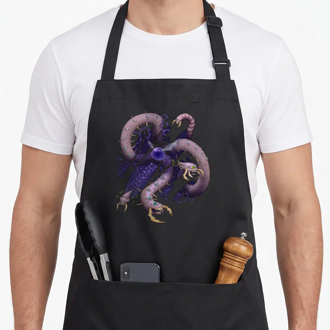 Eater logic apron - Multi-headed purple monster with tan claws and blue eyes, diagonal TERRARIA text — shown on a black cotton canvas apron against a white background