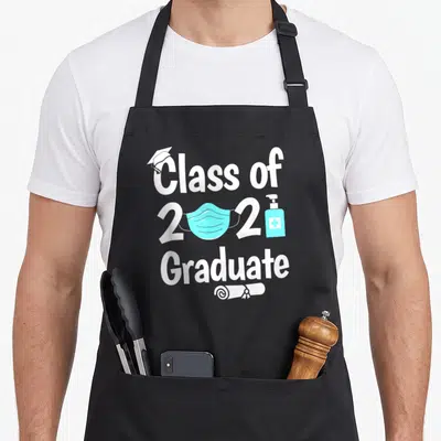 Mask quarantine aprons - Class of 2021 Graduate text with blue mask and sanitizer bottle — shown on a black cotton canvas apron against a white background