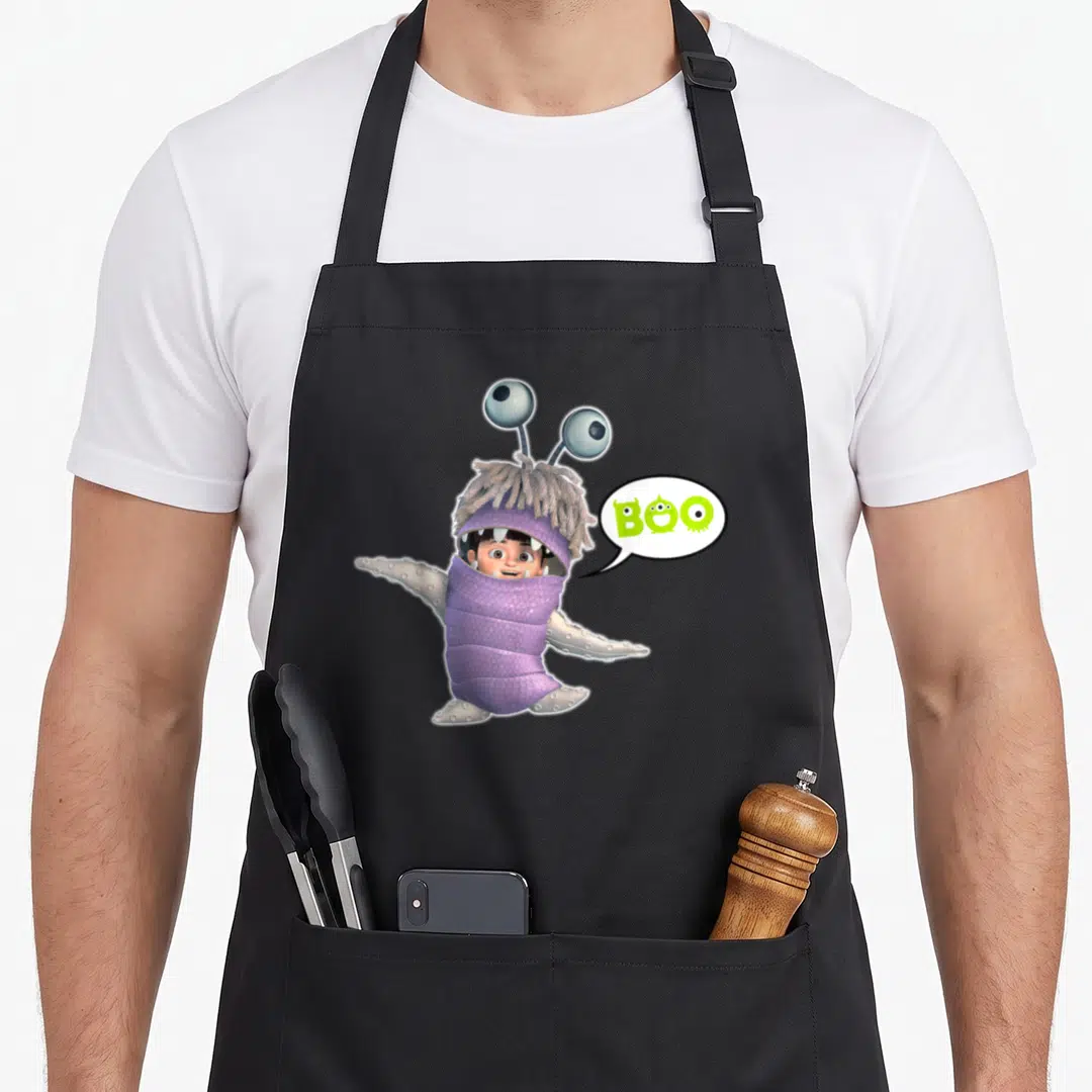Boo bronx apron - Child in purple monster costume with lime green BOO speech bubble — shown on a black cotton canvas apron against a white background