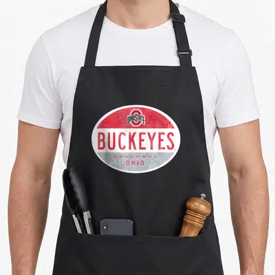 Oval canton ohio apron - Retro oval logo with red white grey bands and Buckeyes Columbus Ohio text — shown on a black cotton canvas apron against a white background
