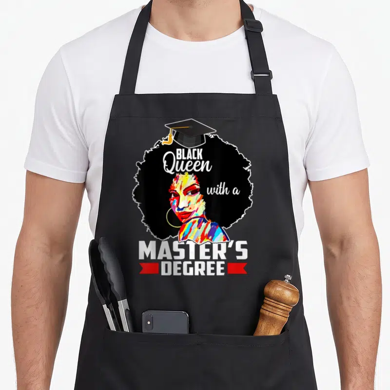Educated master apron - Paint splatter woman face inside black afro with graduation cap and degree text flanked by red — shown on a black cotton canvas apron against a white background