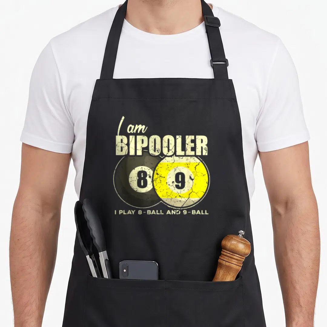 Billard billiards lover apron - Distressed text I am Bipooler above overlapping black 8 and yellow 9 billiard balls — shown on a black cotton canvas apron against a white background