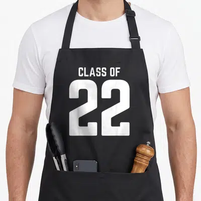 Graduation grad senior apron - White text reading CLASS OF 22 in stacked block letters — shown on a black cotton canvas apron against a white background