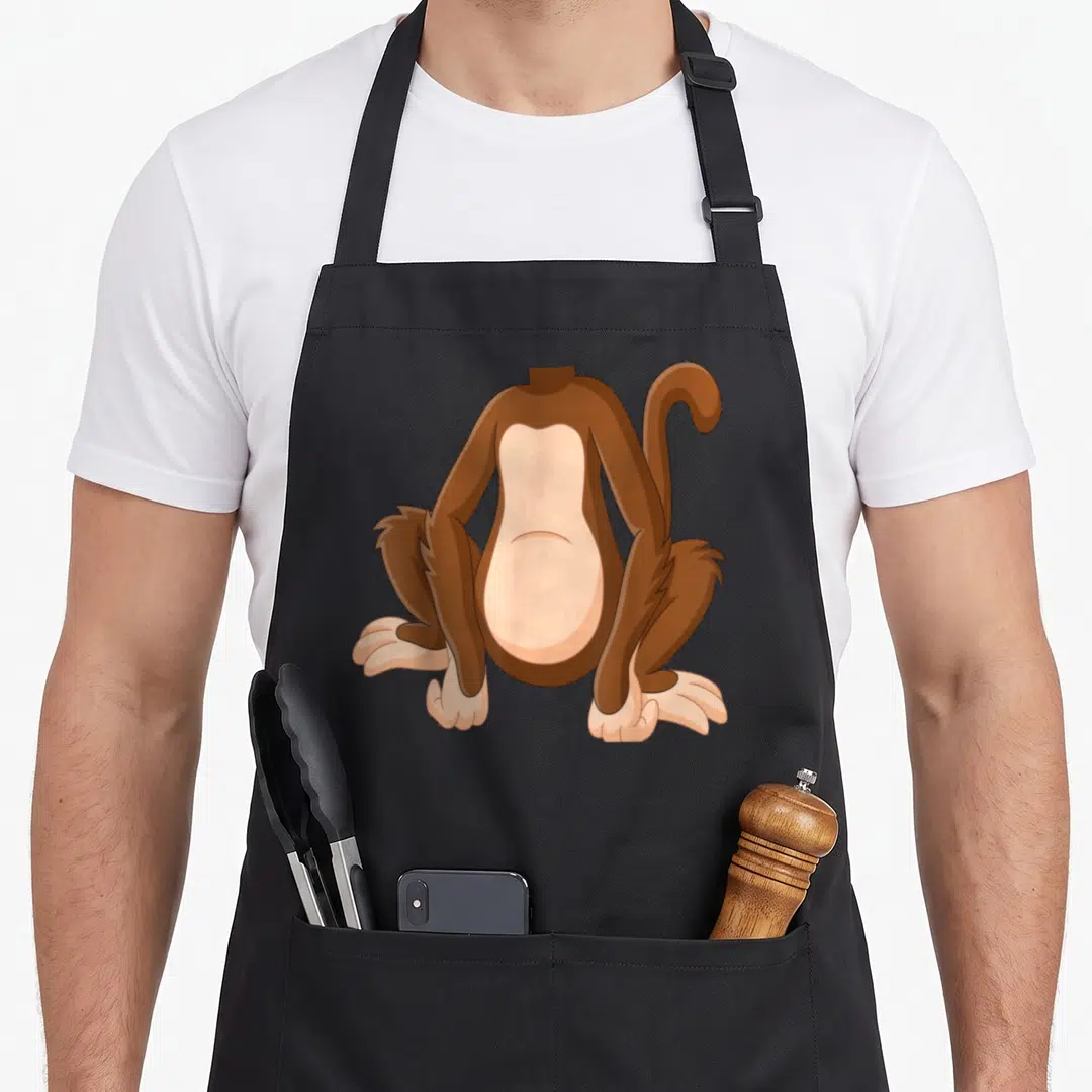 Costume monkey apron - Brown and tan cartoon monkey body sitting facing forward without a head — shown on a black cotton canvas apron against a white background