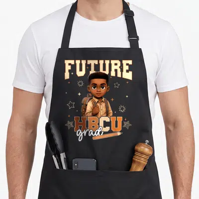 Hbcu motivational grade apron - Cartoon boy with backpack surrounded by stars and FUTURE HBCU grad text — shown on a black cotton canvas apron against a white background