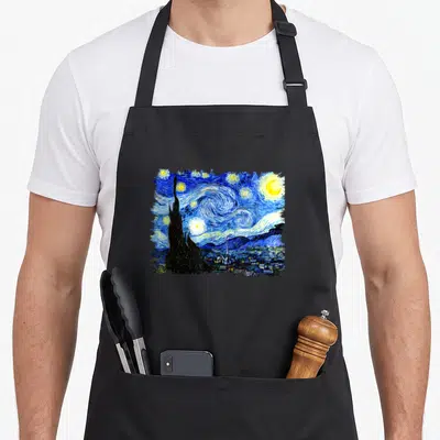 Special van gogh apron - Swirling blue night sky with yellow moon and stars above dark cypress tree and village — shown on a black cotton canvas apron against a white background