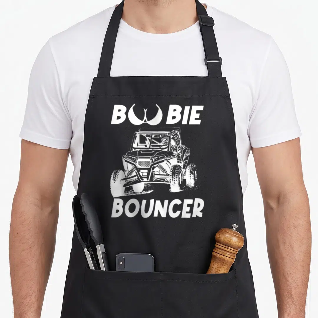 Boobie utv apron - White UTV centered between BOOBIE and BOUNCER text with stylized O — shown on a black cotton canvas apron against a white background