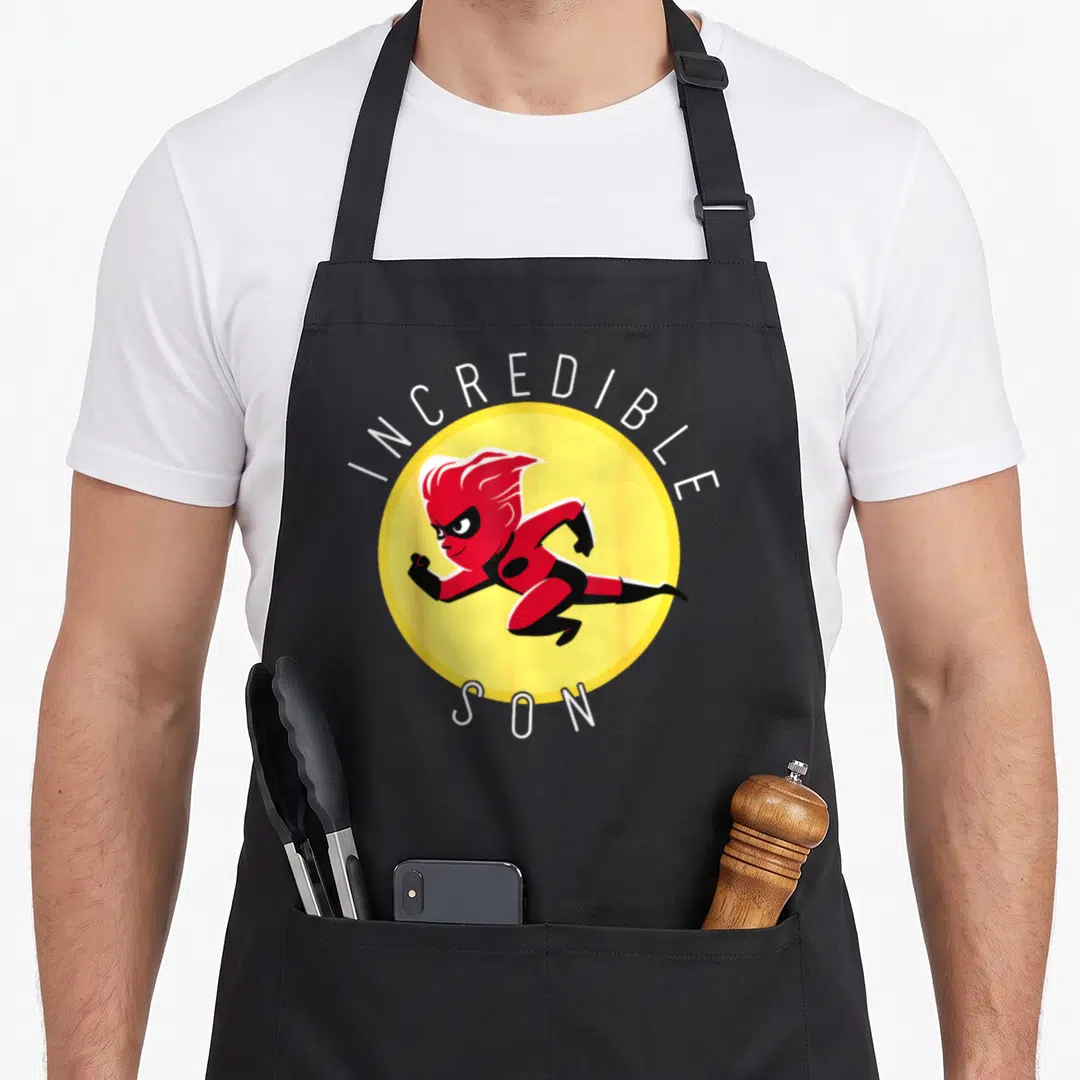 Incredible dad and son aprons - Red superhero running inside yellow circle with white INCREDIBLE SON text — shown on a black cotton canvas apron against a white background