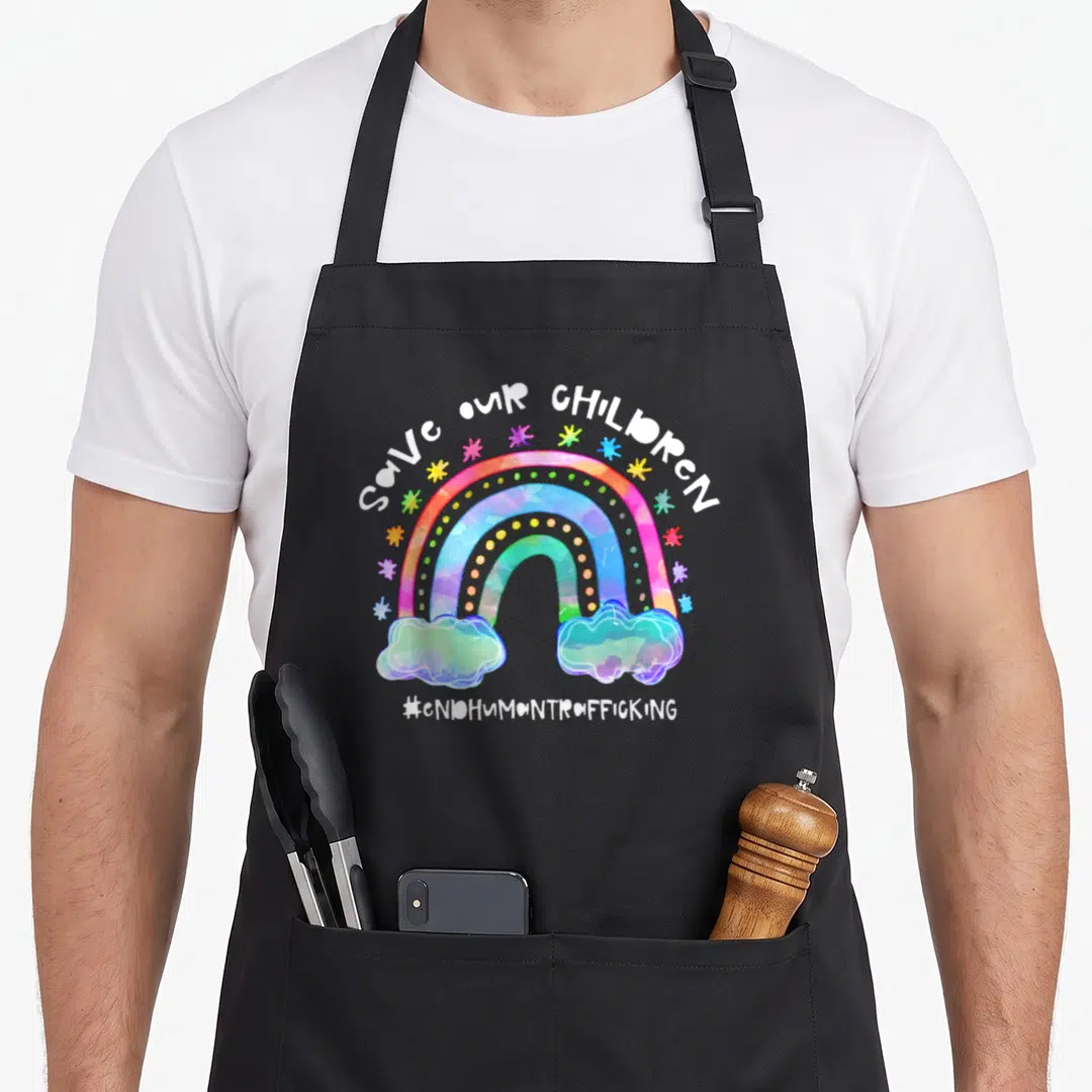 Cute save human trafficking awareness apron - Watercolor rainbow with two clouds, multicolored stars, and SAVE OUR — shown on a black cotton canvas apron against a white background